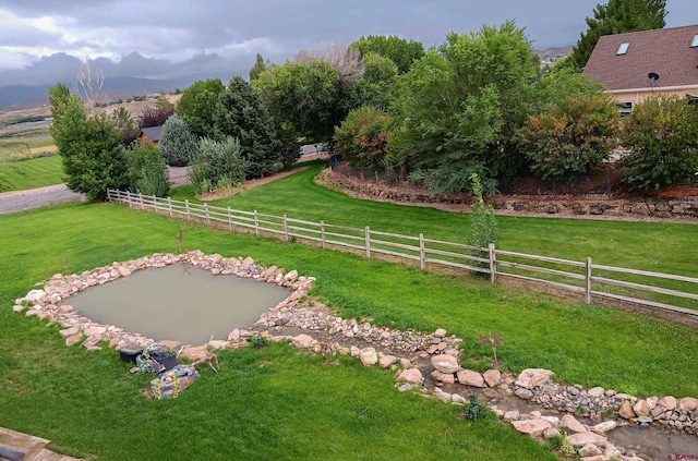 view of yard with a rural view and fence