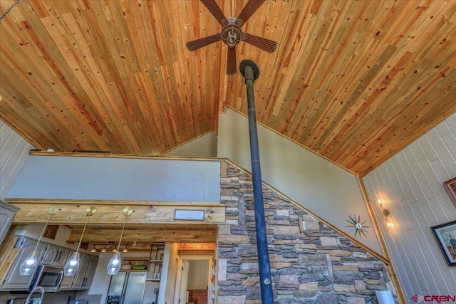 room details featuring wooden ceiling, a ceiling fan, and beam ceiling