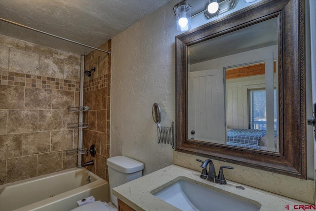 full bathroom with vanity, shower / bath combination, a textured ceiling, toilet, and a textured wall