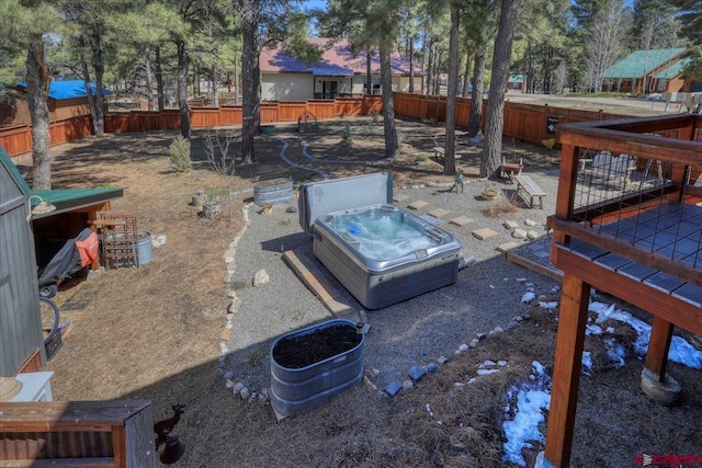 view of yard featuring a fenced backyard and a hot tub