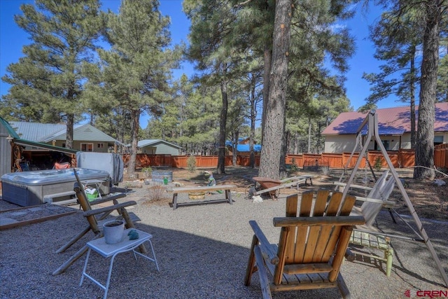 view of yard featuring a patio area, a hot tub, and a fenced backyard