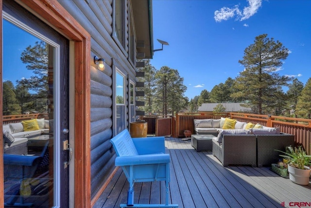 wooden terrace with an outdoor hangout area