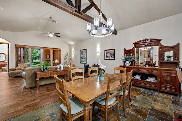 dining area featuring visible vents, beam ceiling, arched walkways, stone tile flooring, and ceiling fan with notable chandelier