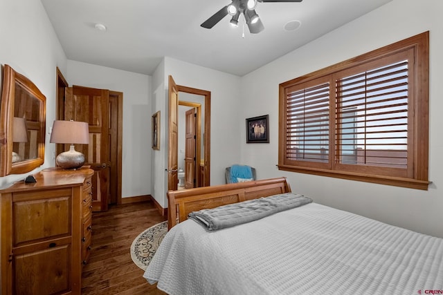 bedroom featuring baseboards, dark wood finished floors, and a ceiling fan