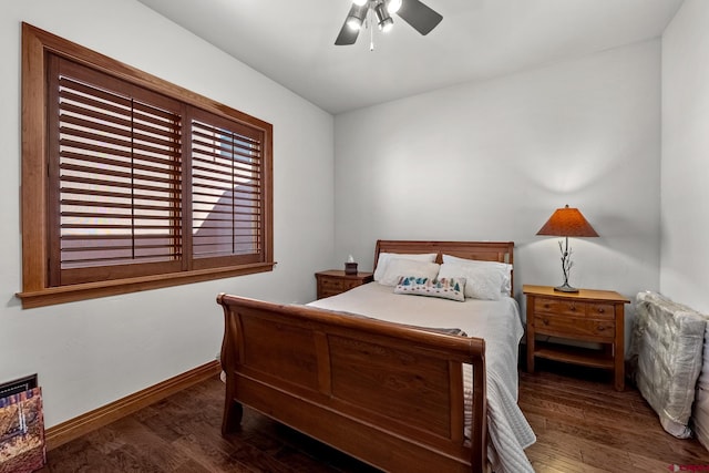 bedroom featuring ceiling fan, baseboards, and wood finished floors