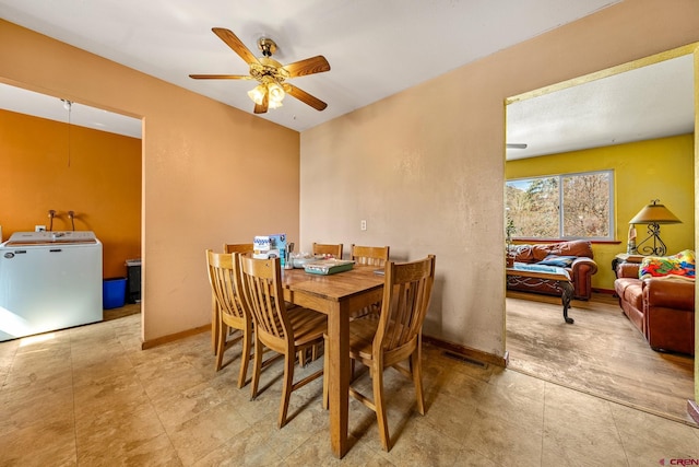 dining room with washer / clothes dryer, visible vents, baseboards, and ceiling fan