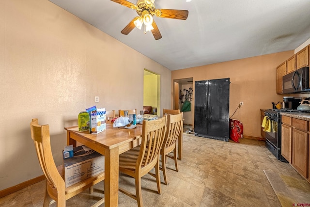 dining space featuring baseboards and ceiling fan