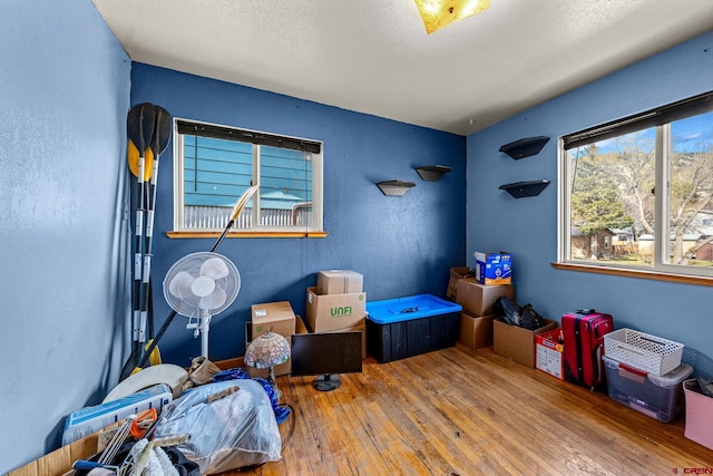 bedroom featuring a textured ceiling and hardwood / wood-style floors