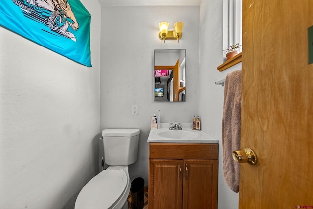 bathroom featuring toilet and vanity