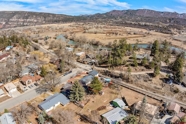 drone / aerial view with a water and mountain view