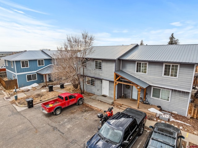 view of front of house with fence and metal roof