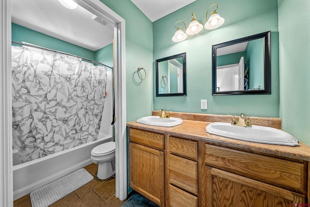 bathroom featuring a sink, visible vents, double vanity, and tile patterned floors