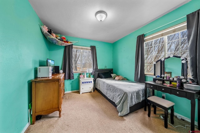 carpeted bedroom featuring baseboards