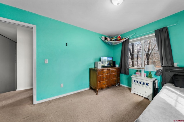 bedroom with baseboards and carpet floors