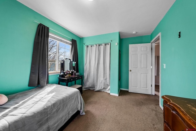 carpeted bedroom featuring baseboards