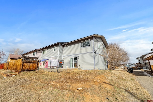 rear view of property with fence