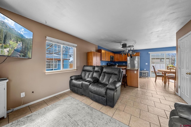 living room featuring light tile patterned flooring and baseboards