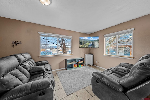 living room with light tile patterned floors and baseboards