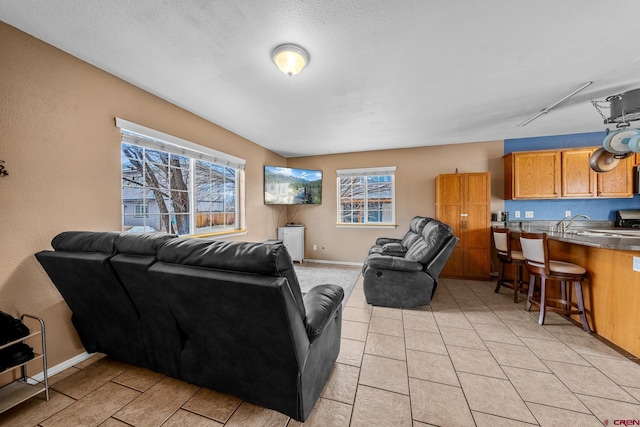 living room with light tile patterned floors and baseboards