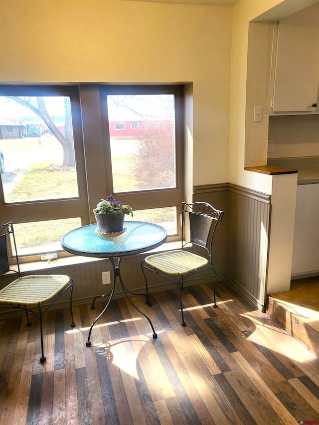 dining space featuring hardwood / wood-style floors and wainscoting