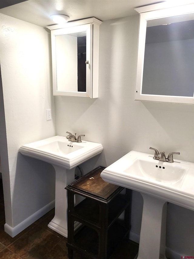 bathroom with a sink and baseboards