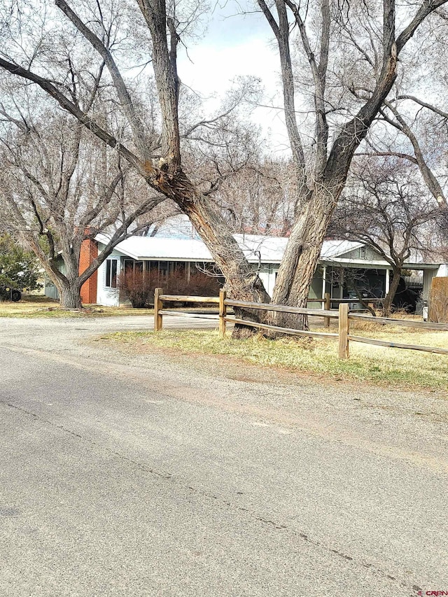 view of front facade with a fenced front yard and a chimney