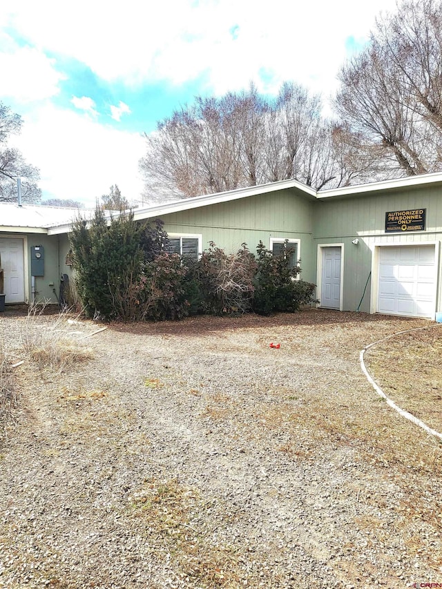 view of side of property featuring an attached garage