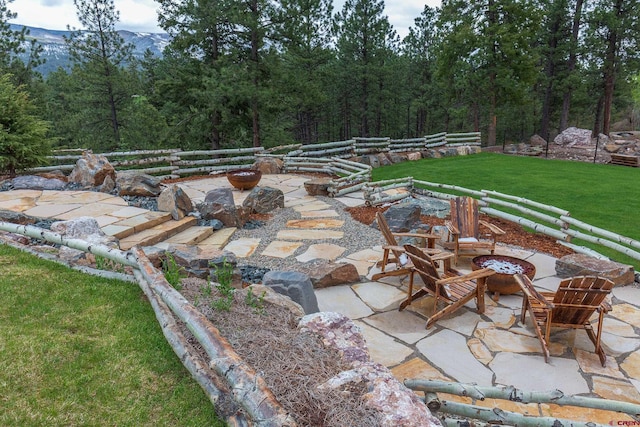 view of patio with a mountain view and a fire pit