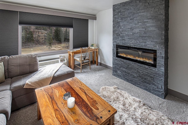 carpeted living area featuring baseboards, an AC wall unit, and a glass covered fireplace