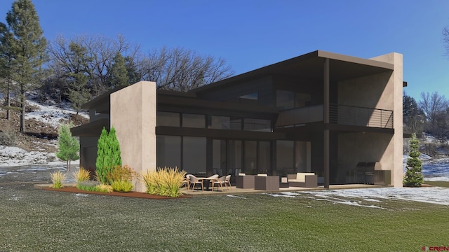 rear view of house featuring a balcony, an outdoor living space, a patio, and stucco siding