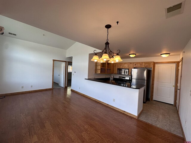 530 Redcliff Cir Unit F-203, Ridgway, CO 81432 - kitchen featuring visible vents, a chandelier, appliances with stainless steel finishes, a peninsula, and wood finished floors