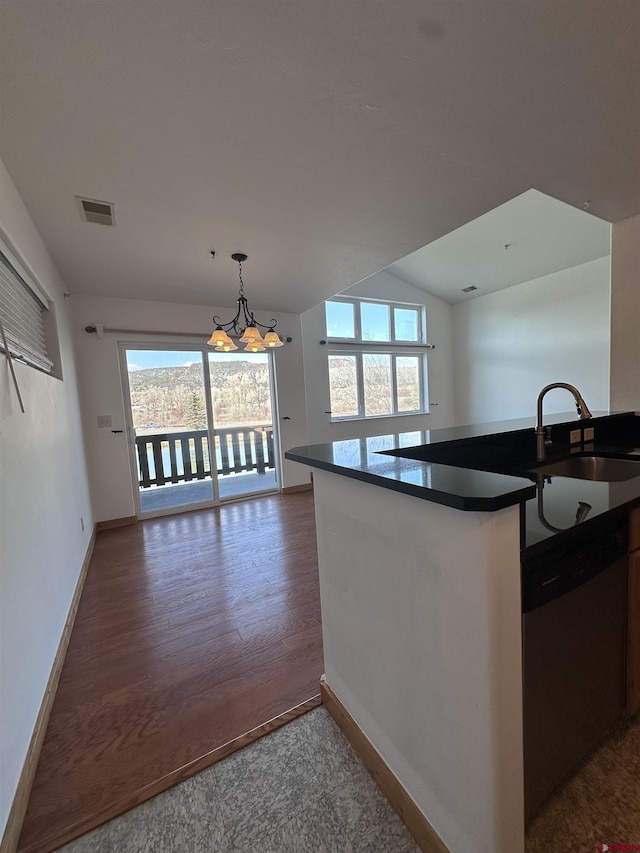 530 Redcliff Cir Unit F-203, Ridgway, CO 81432 - kitchen featuring visible vents, dishwasher, dark countertops, a notable chandelier, and open floor plan