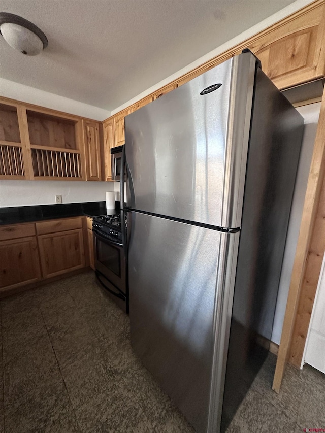 530 Redcliff Cir Unit F-203, Ridgway, CO 81432 - kitchen featuring open shelves, appliances with stainless steel finishes, a textured ceiling, dark countertops, and dark floors