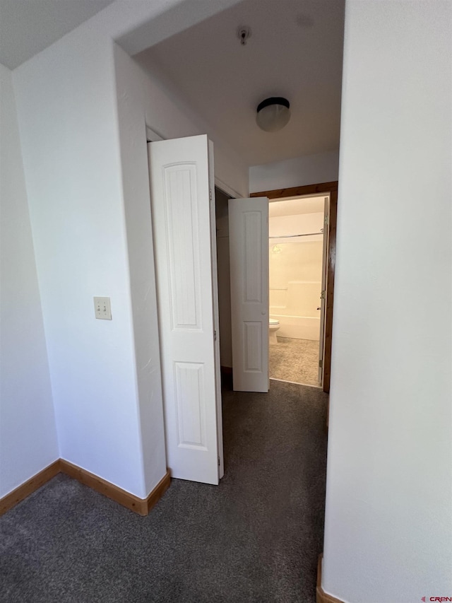 530 Redcliff Cir Unit F-203, Ridgway, CO 81432 - hallway with baseboards and dark colored carpet