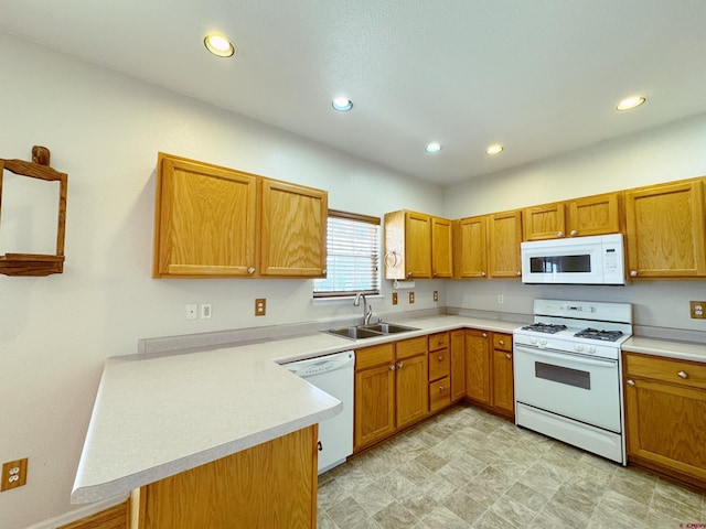 kitchen featuring a sink, recessed lighting, white appliances, a peninsula, and light countertops