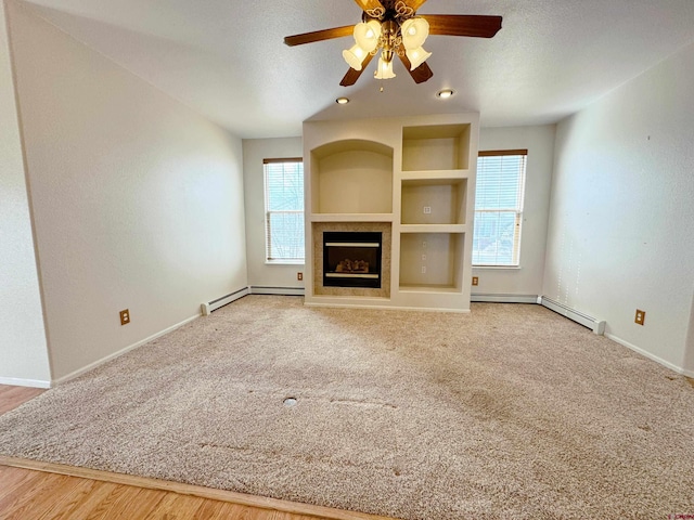 unfurnished living room featuring a baseboard heating unit, a textured ceiling, a fireplace, and a ceiling fan