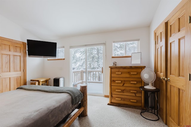 bedroom featuring vaulted ceiling and light carpet