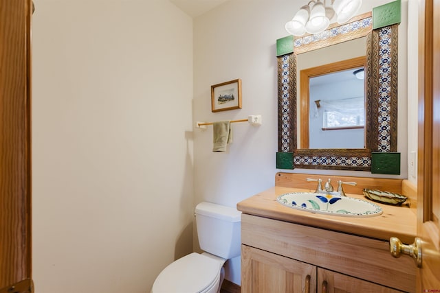 bathroom featuring toilet and vanity