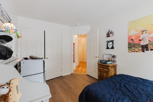 bedroom with baseboards and wood finished floors