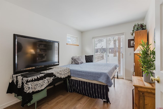 bedroom with baseboards and wood finished floors