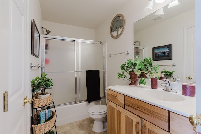 bathroom with shower / bath combination with glass door, visible vents, toilet, and vanity