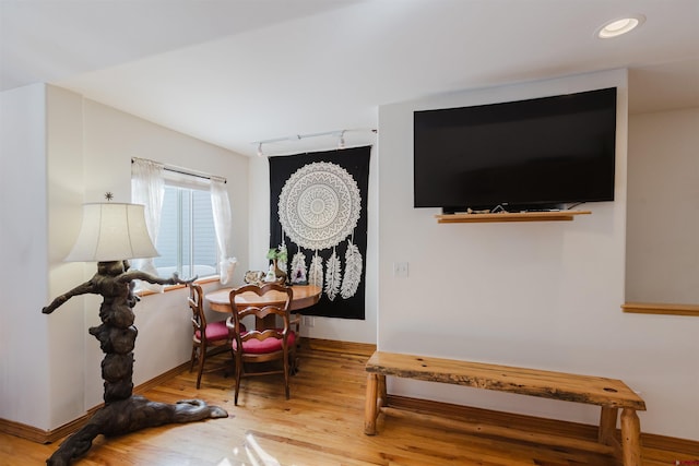 sitting room with recessed lighting, baseboards, wood finished floors, and rail lighting