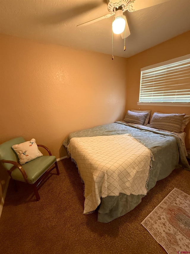 bedroom featuring a ceiling fan and carpet