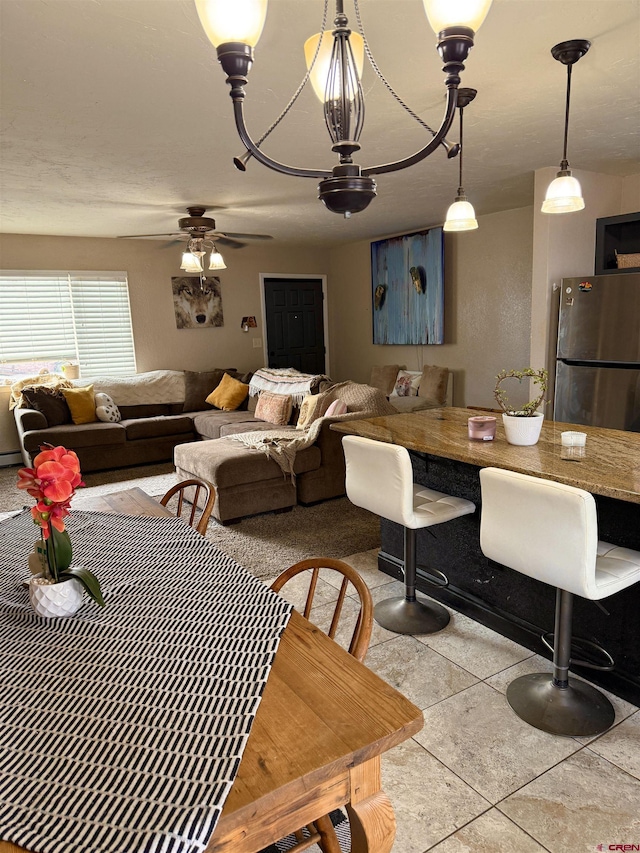 dining space with tile patterned floors and ceiling fan