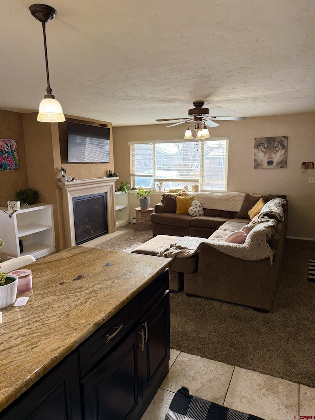 living room with a fireplace and a ceiling fan