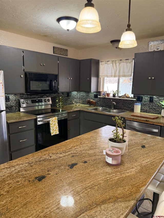 kitchen featuring decorative backsplash, gray cabinets, appliances with stainless steel finishes, and a sink