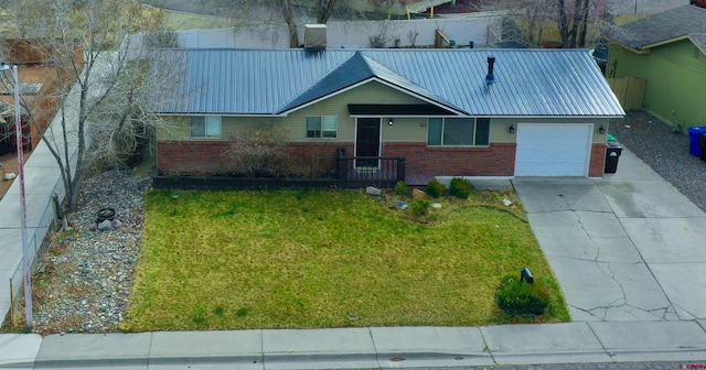 ranch-style home featuring brick siding, driveway, metal roof, and a garage