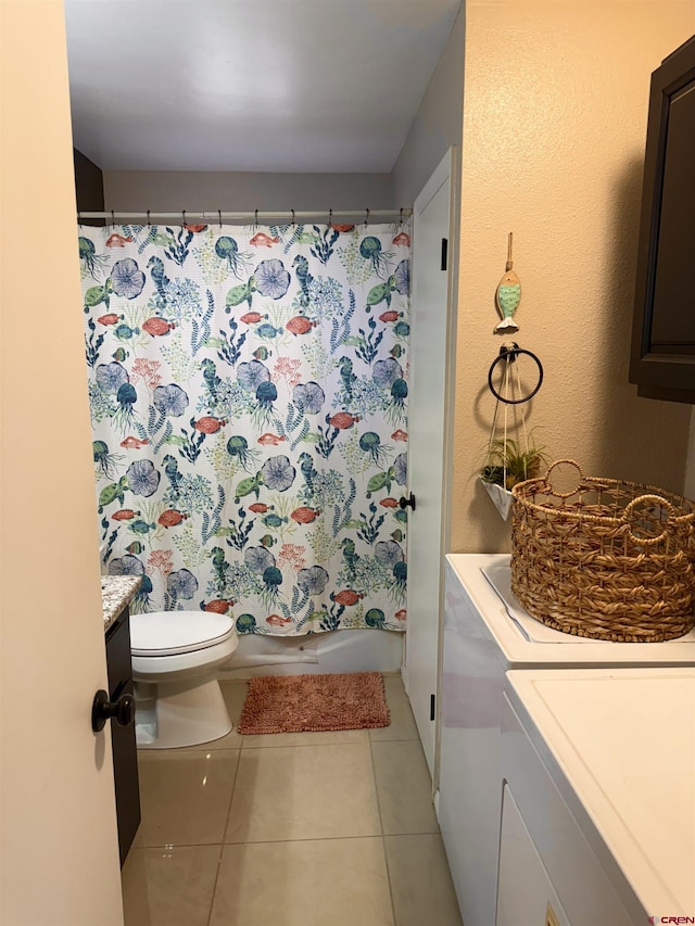 bathroom with shower / bathtub combination with curtain, toilet, washing machine and dryer, tile patterned flooring, and vanity