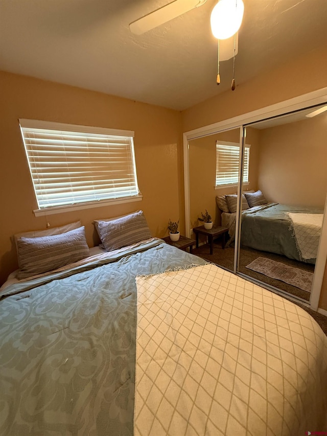 unfurnished bedroom with a closet, a ceiling fan, and carpet flooring