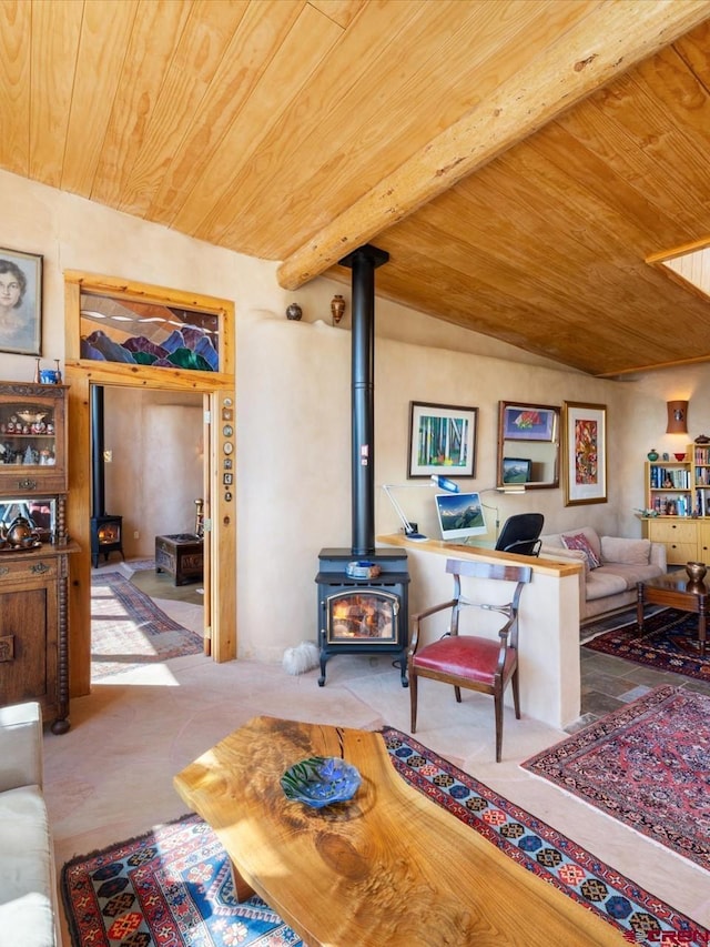 living room featuring beamed ceiling, wooden ceiling, and a wood stove